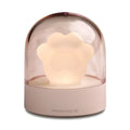 Pink and grey cat paw shaped USB night light with a music box feature on a desktop.