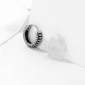 Silver geometric retro twist earrings with stripes made from titanium steel on a white background.