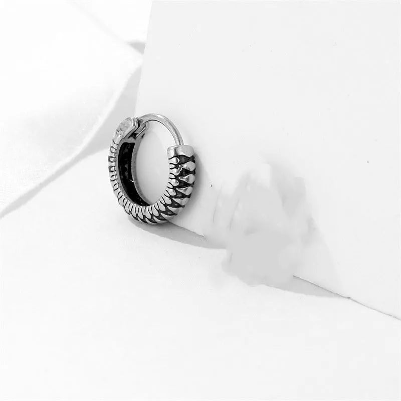 Silver geometric retro twist earrings with stripes made from titanium steel on a white background.