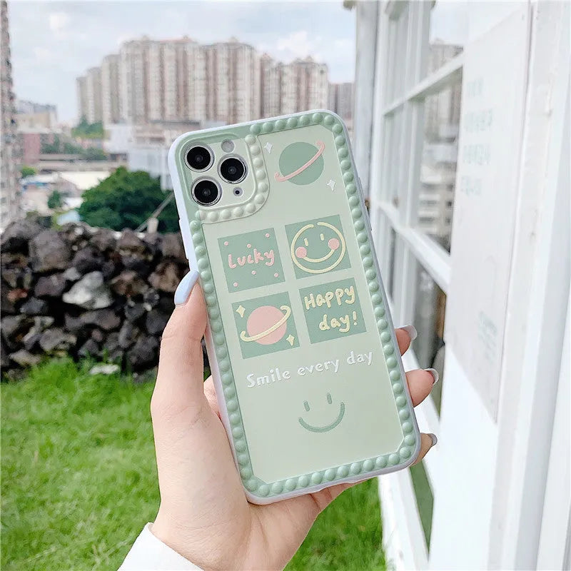 Green TPU iPhone case featuring a geometric smiley face and polka dot frame design.