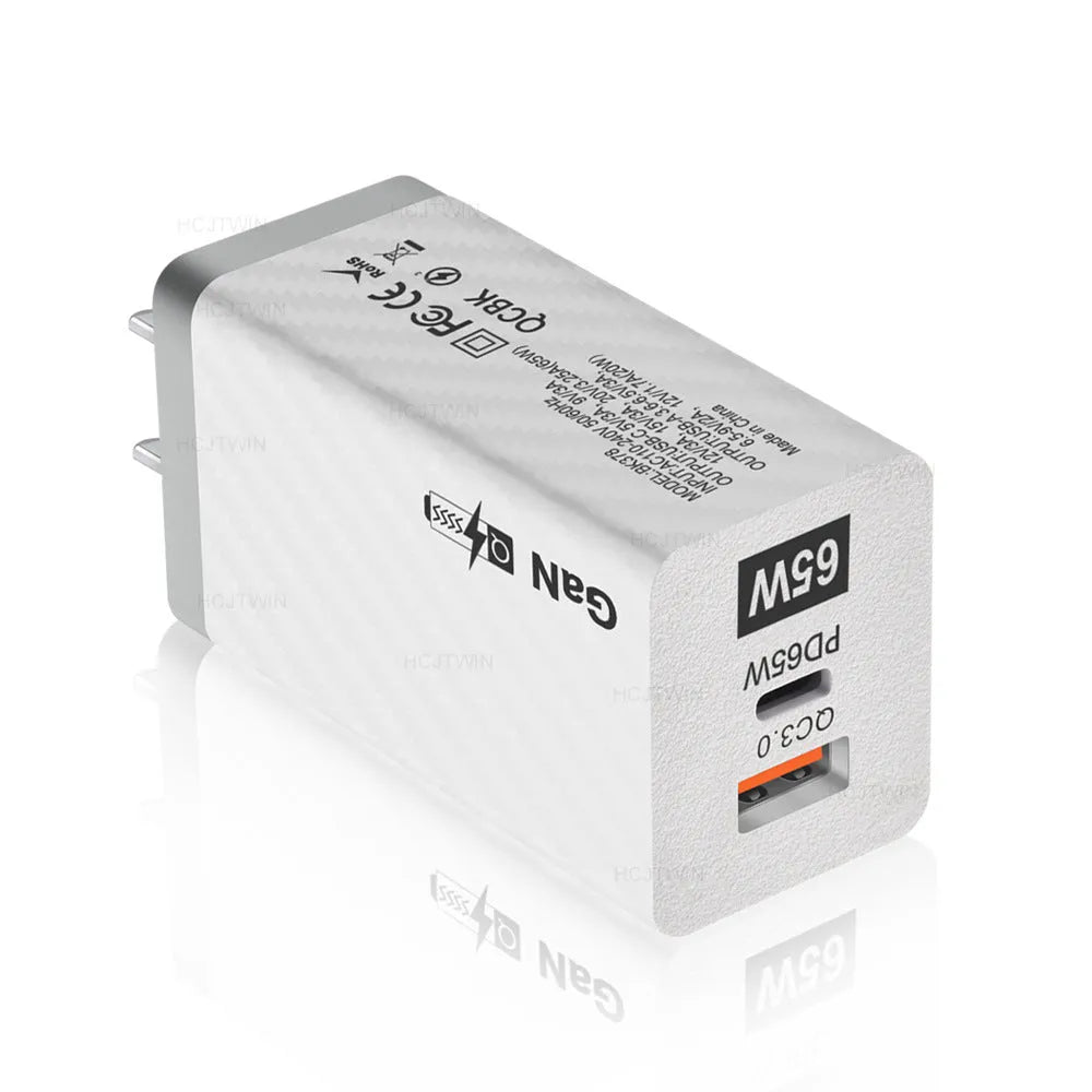 White and black 65W Gallium Nitride USB-PD laptop charger with EU, UK, and US plug options.