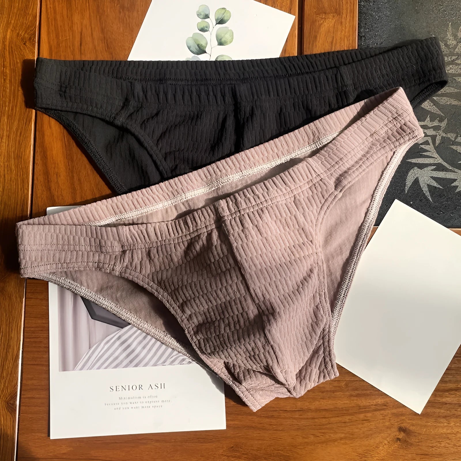 Men's pure cotton triangle underwear briefs in solid colours like black, white, and apricot on a mid-waist fit model.