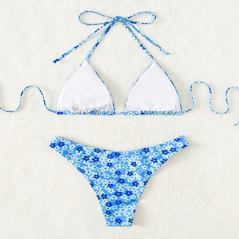 Blue printed women's swimsuit set with lace-up halter neck top and high-waisted side-split shorts.