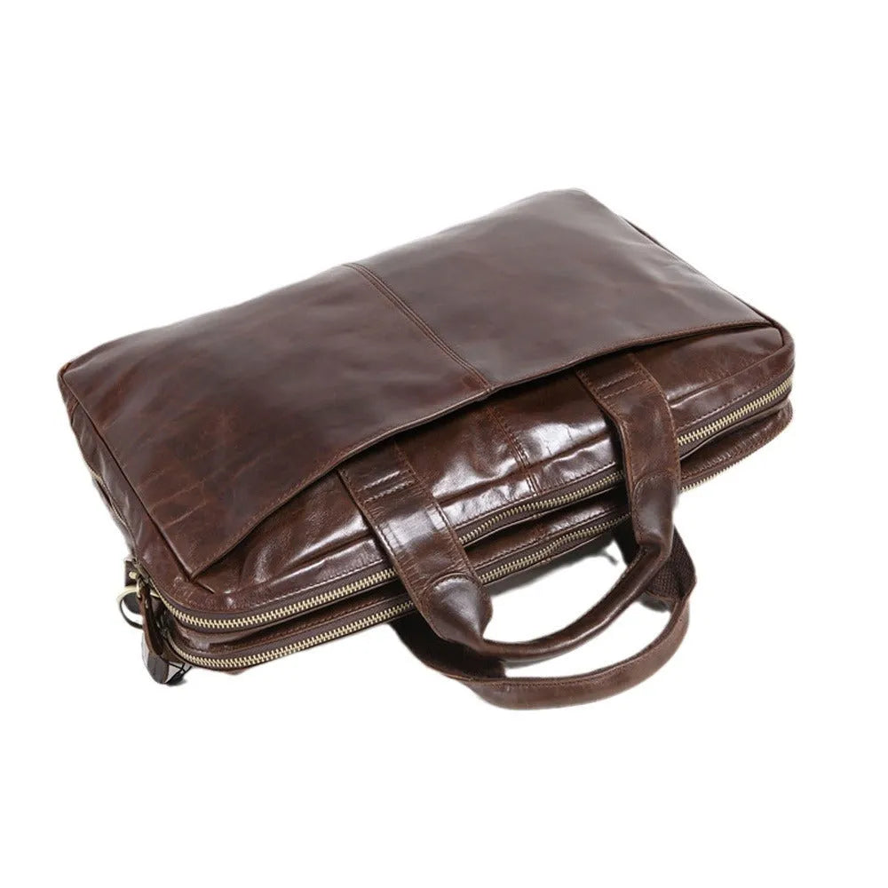 Brown leather men's business briefcase with 18 inch capacity and visible cowhide patterning