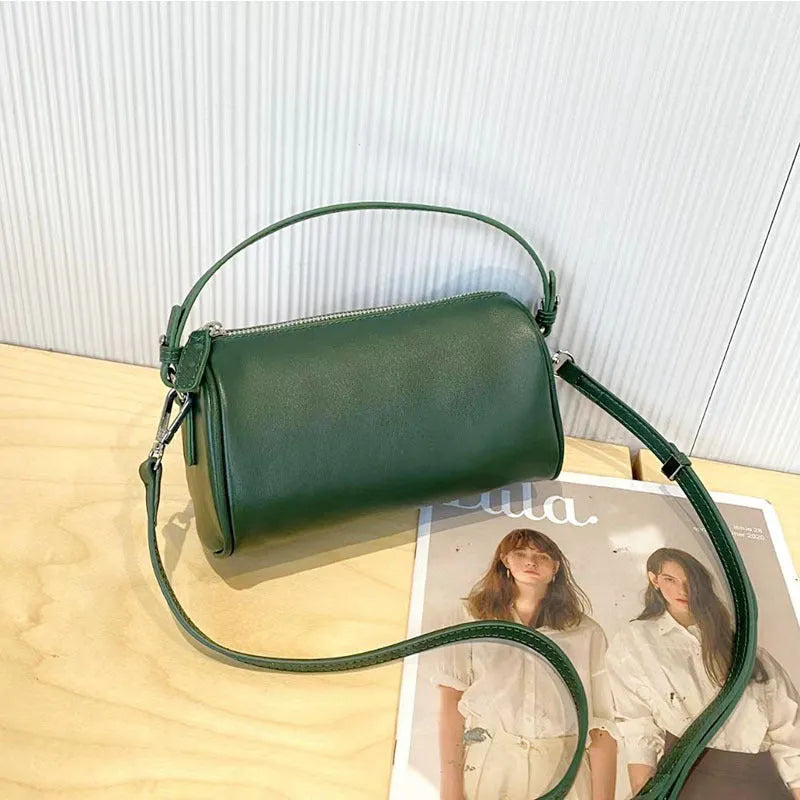 Soft genuine leather cylindrical crossbody bag in street style, shown in black, with a single strap.