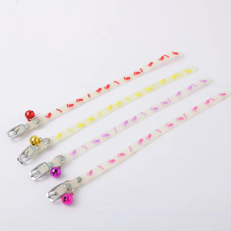 Luminous adjustable cat collar with bell in silicone and metal, showing paw print design for night visibility.