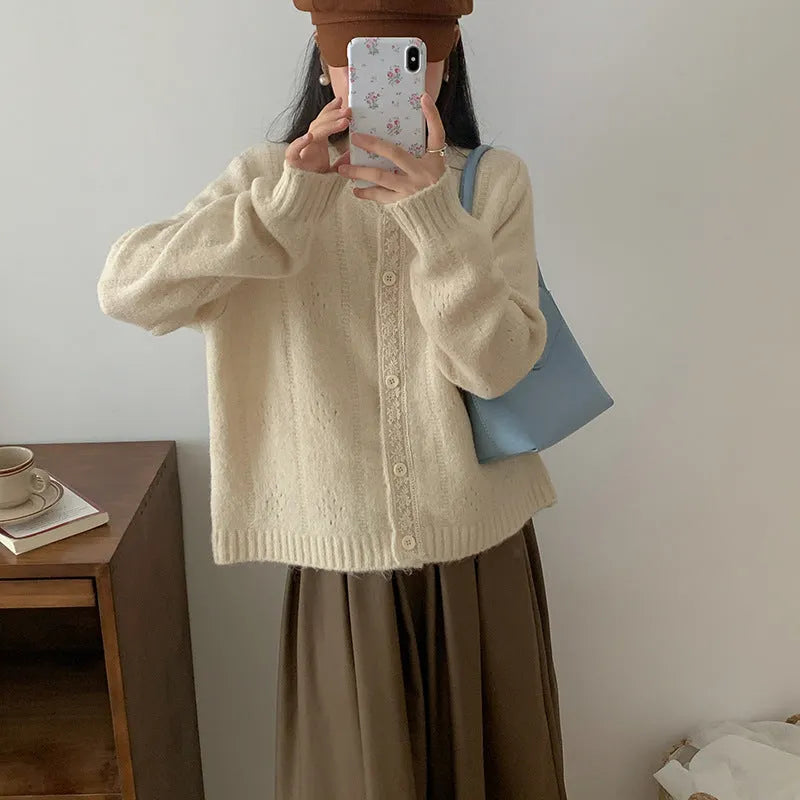 Loose apricot-coloured Korean-style cardigan sweater coat with regular sleeves on a hanger.