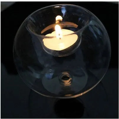 Handmade round hollow clear glass candle holder with a tea light inside, showing European style design.