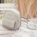 Women's black PU backpack purse with letter design and shoulder strap showing compact 18.5cm length