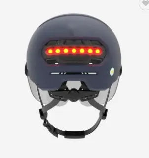 Adult cycling helmet with integrated red LED brake and tail light on the back, shown in sizes M and L.