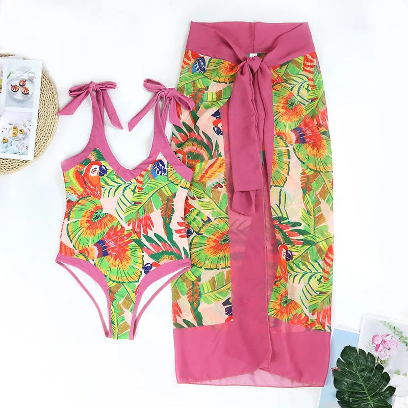 Women's pink floral print one-piece swimsuit with V-neck, covered belly, and attached skirt for swimming