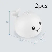 Electric whale-shaped baby bath toy with water spray, LED lights, and automatic water sensor