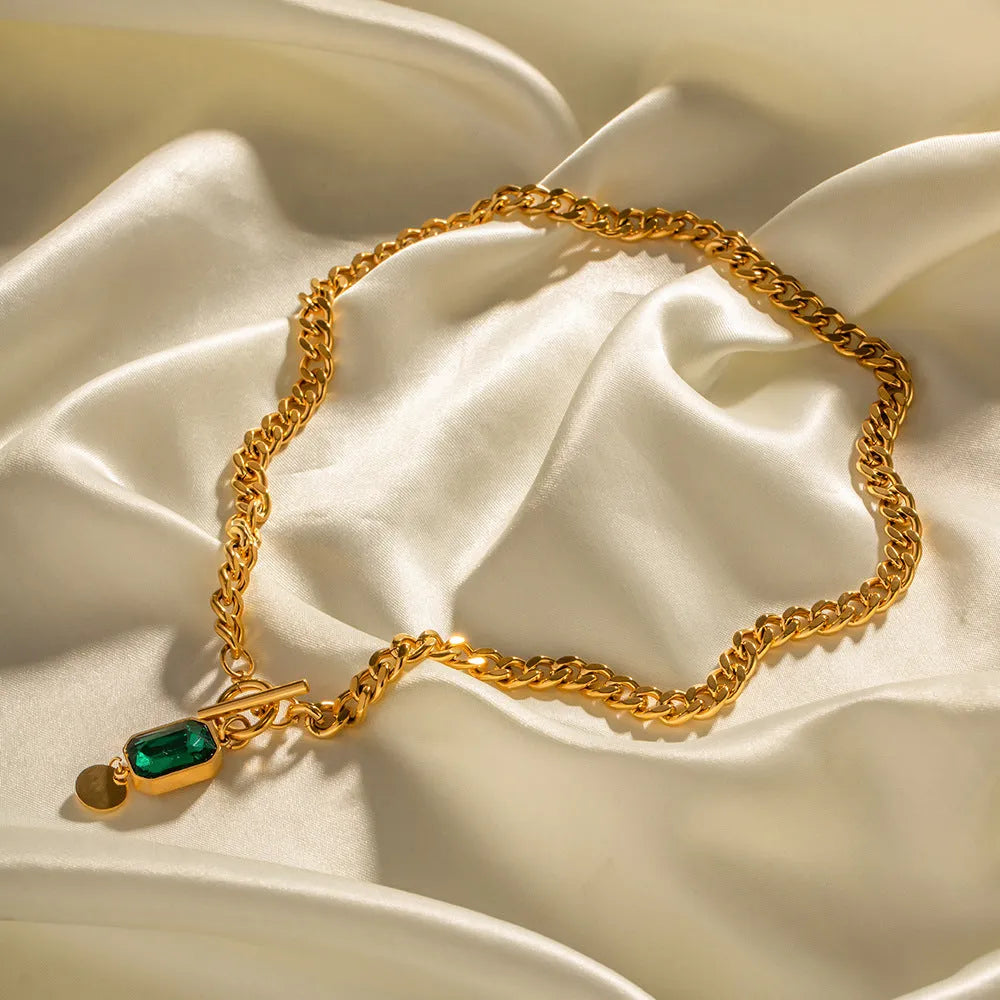Gold electroplated titanium steel necklace with geometric emerald zircon pendant on Cuban link chain