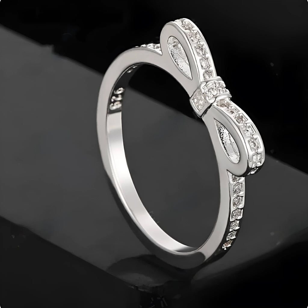 Silver-coloured bow design ring with sparkling rhinestone zircon crystal decoration.