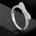 Silver-coloured bow design ring with sparkling rhinestone zircon crystal decoration.