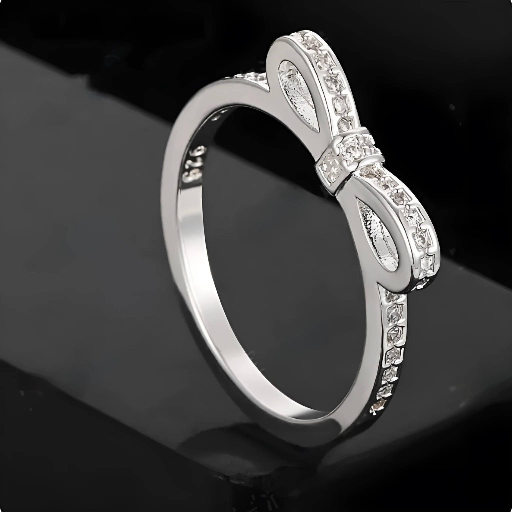 Silver-coloured bow design ring with sparkling rhinestone zircon crystal decoration.