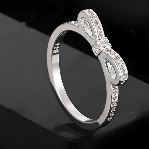 Silver-coloured bow design ring with sparkling rhinestone zircon crystal decoration.