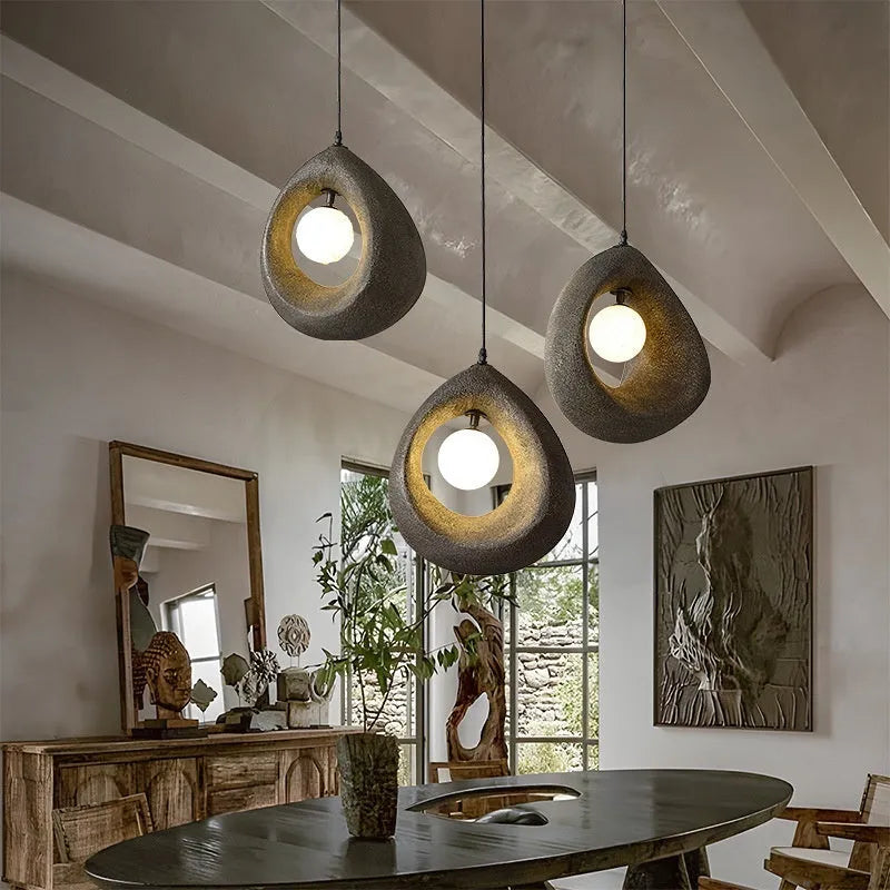Sili Style modern pendant light with milky white glass shade in a dining room setting.