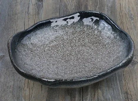 Creative Japanese style irregular shaped porcelain sashimi bowl with floral decoration and a small sauce dish
