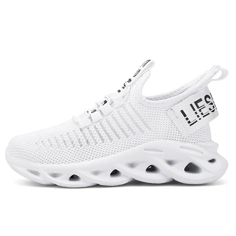 Children's black Velcro sneakers with fabric upper and textured EVA sole on a white background.