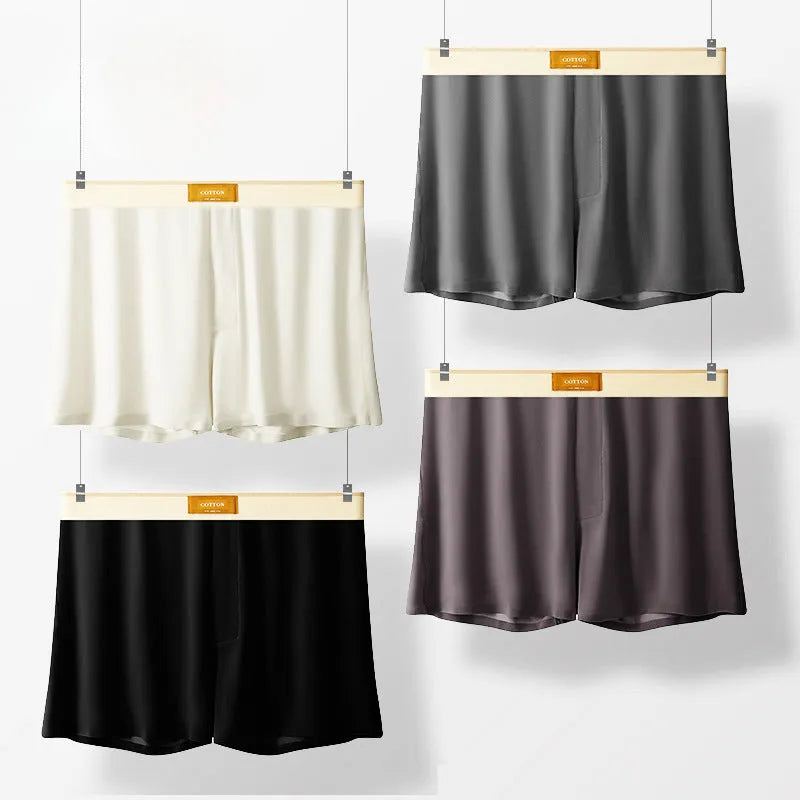 Pack of three men's solid colour loose fit ice silk underwear briefs on a grey background.