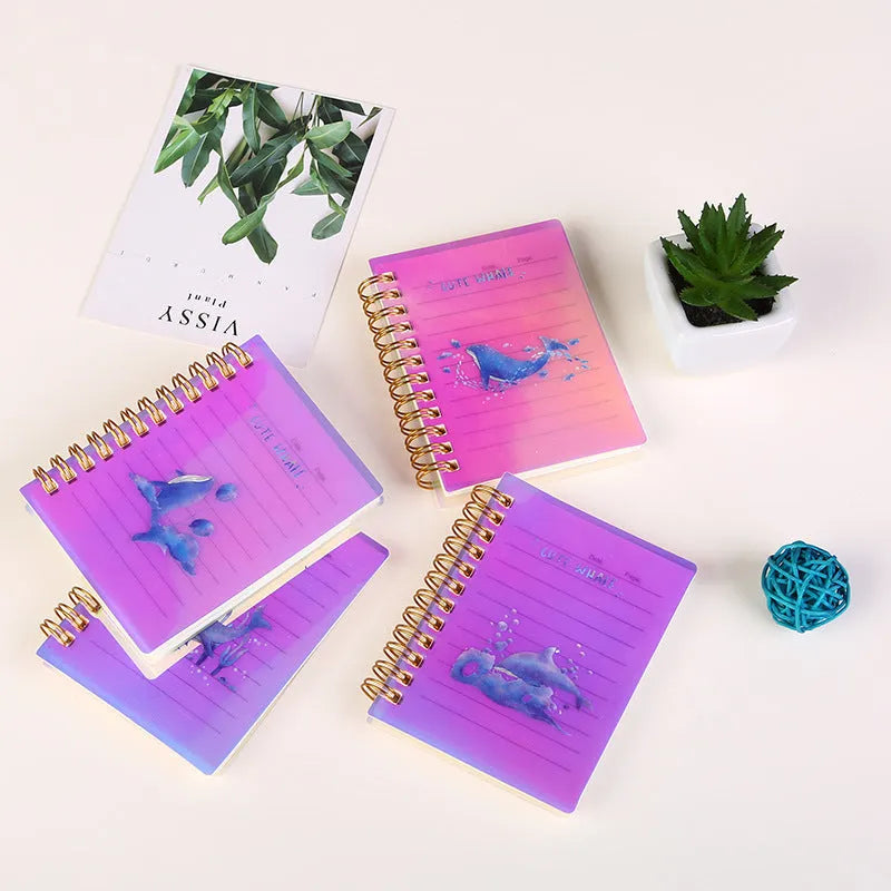 Pack of four rollover coil A7 pocket notebooks showing constellation, sakura, ocean, and universe cover designs