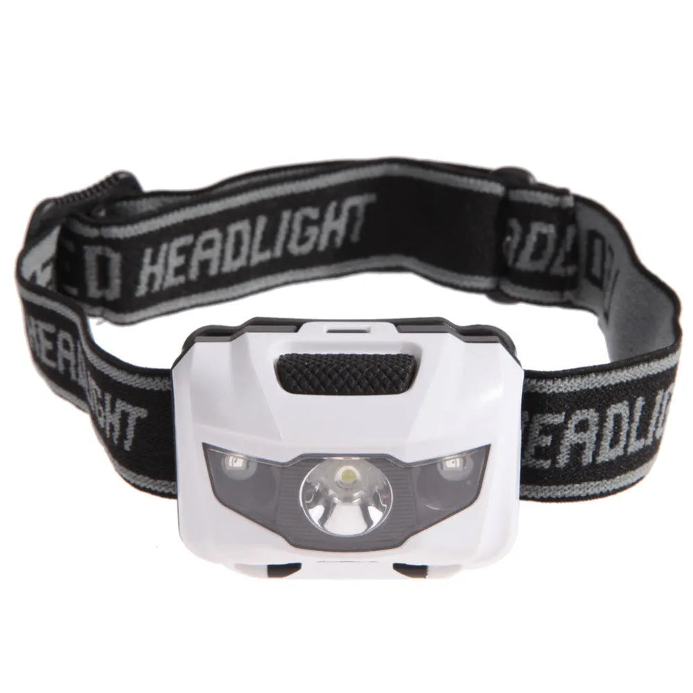 Black head torch with white and red LEDs mounted on adjustable headband for outdoor use