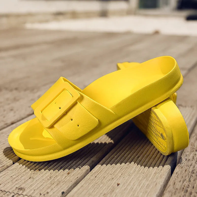 Women's grey blue buckle slippers with a flip-flop design and soft EVA sole on a white background