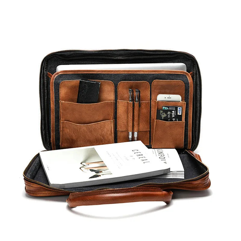 Vintage brown leather men's briefcase open showing internal laptop pocket and document organisers