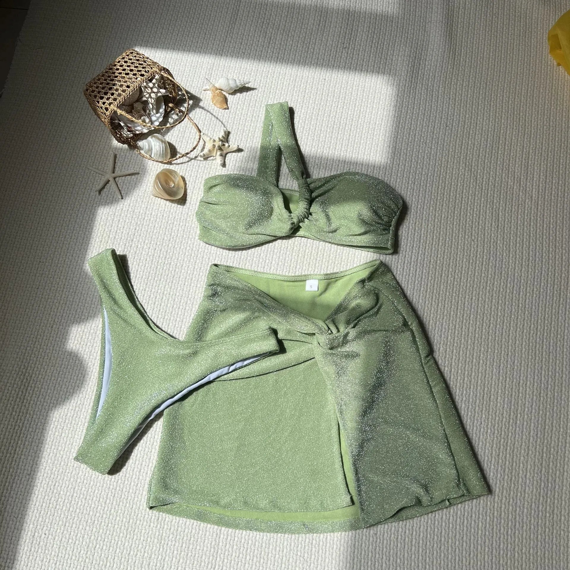 Women's one-shoulder tube top three-piece swimsuit set in glossy polyester fabric with matching skirt