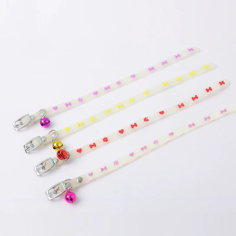 Luminous adjustable cat collar with bell in silicone and metal, showing paw print design for night visibility.