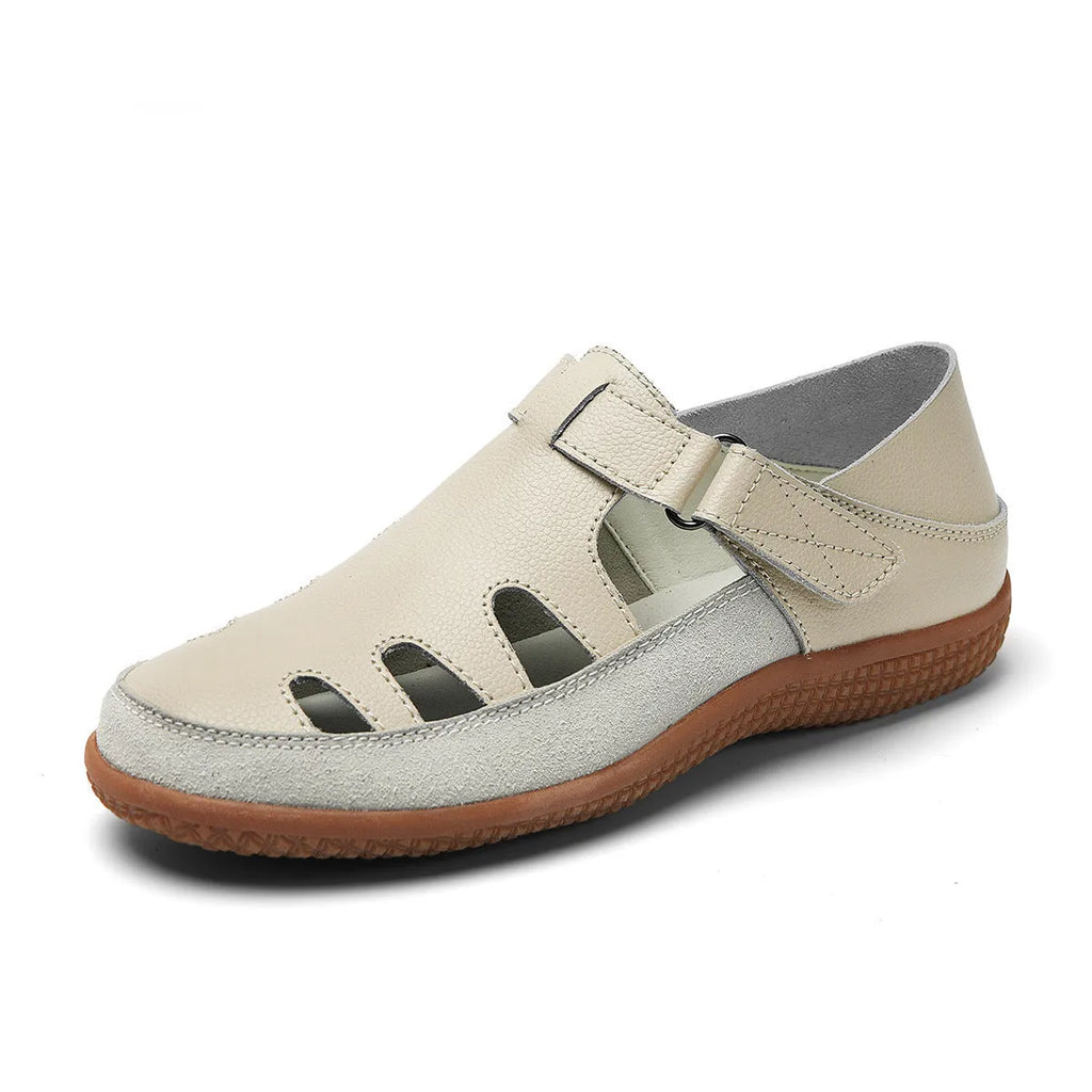 Blue plus size women's flat sandals with hollow-out design and toe cap on a thick rubber sole.