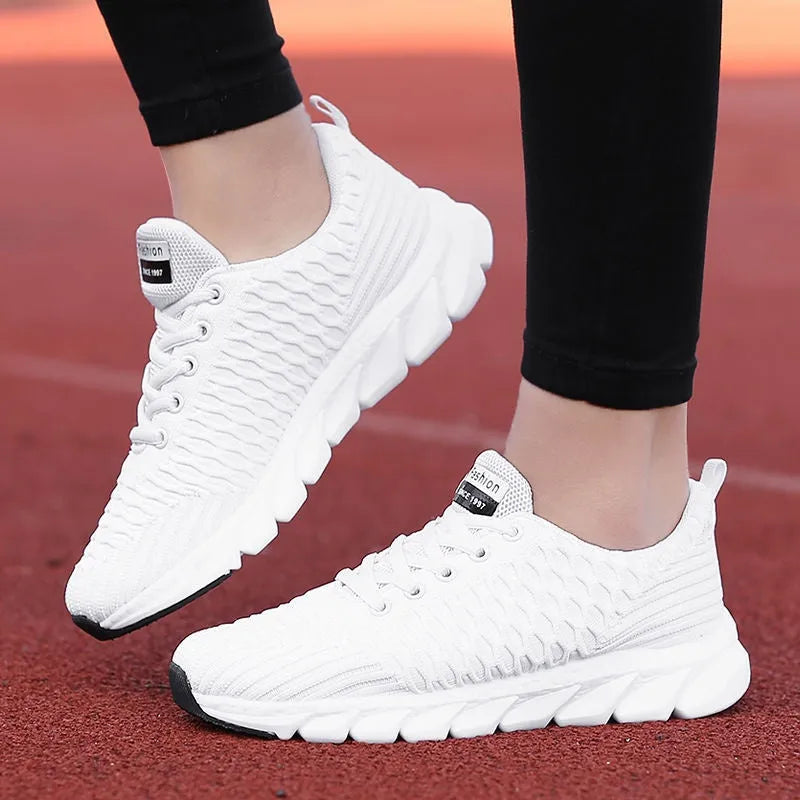 Women's running shoes with fly weaving upper in black, pink, or white colours.