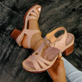 Women's black peep toe wedge sandals with a buckle fastening on a white background.