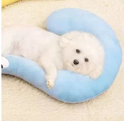 Blue U-shaped cat sleeping mat with moon design next to a yellow question mark shaped pet pillow.