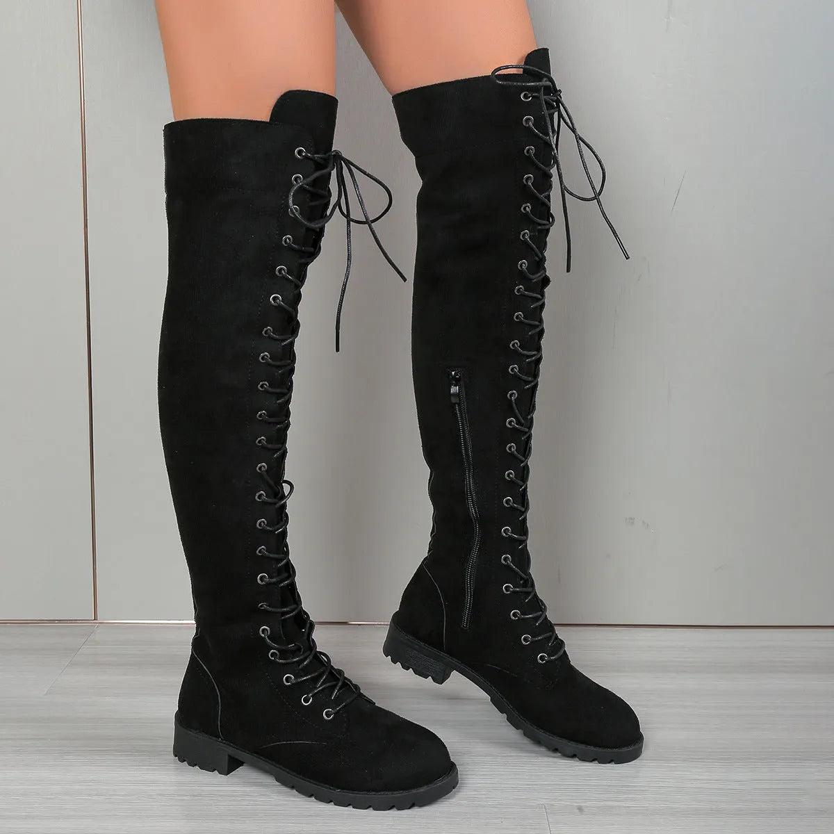 Black lace-up over-the-knee flat heel boots with round toe and leather stitching detail on artificial PU upper.