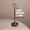 Gold UFO-shaped rechargeable table lamp with touch dimming controls on metallic surface