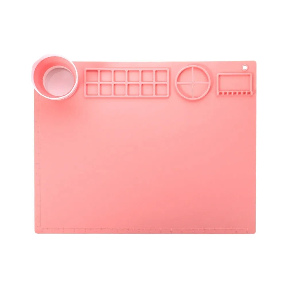 Light blue silicone painting mat with two round bowl compartments, measuring 50 by 40 cm.