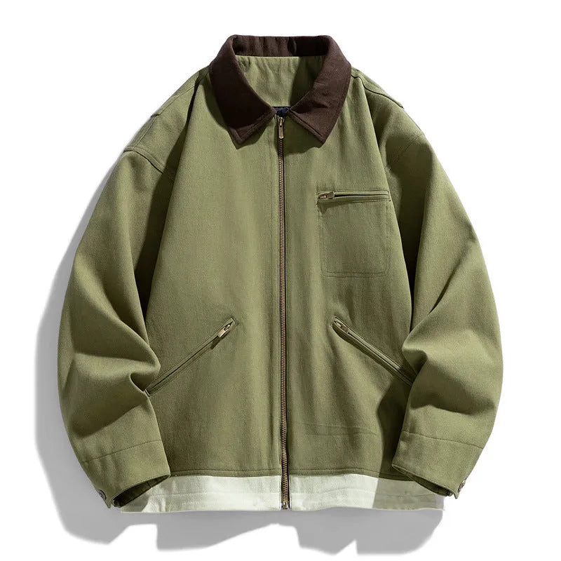 Man wearing a mint green retro workwear jacket with dark contrast lapels and side pockets.