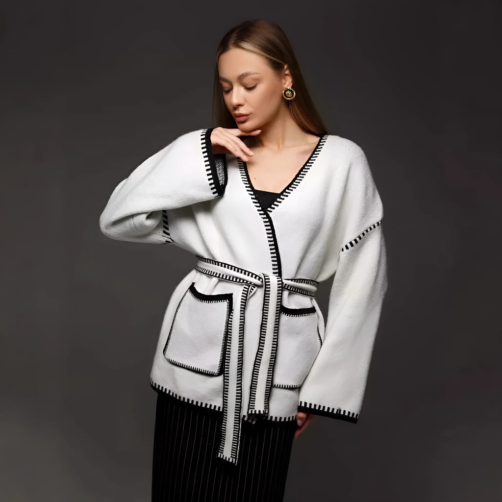 Lace-up front knitted cardigan sweater coat in camel colour, showing loose fit and long sleeves.