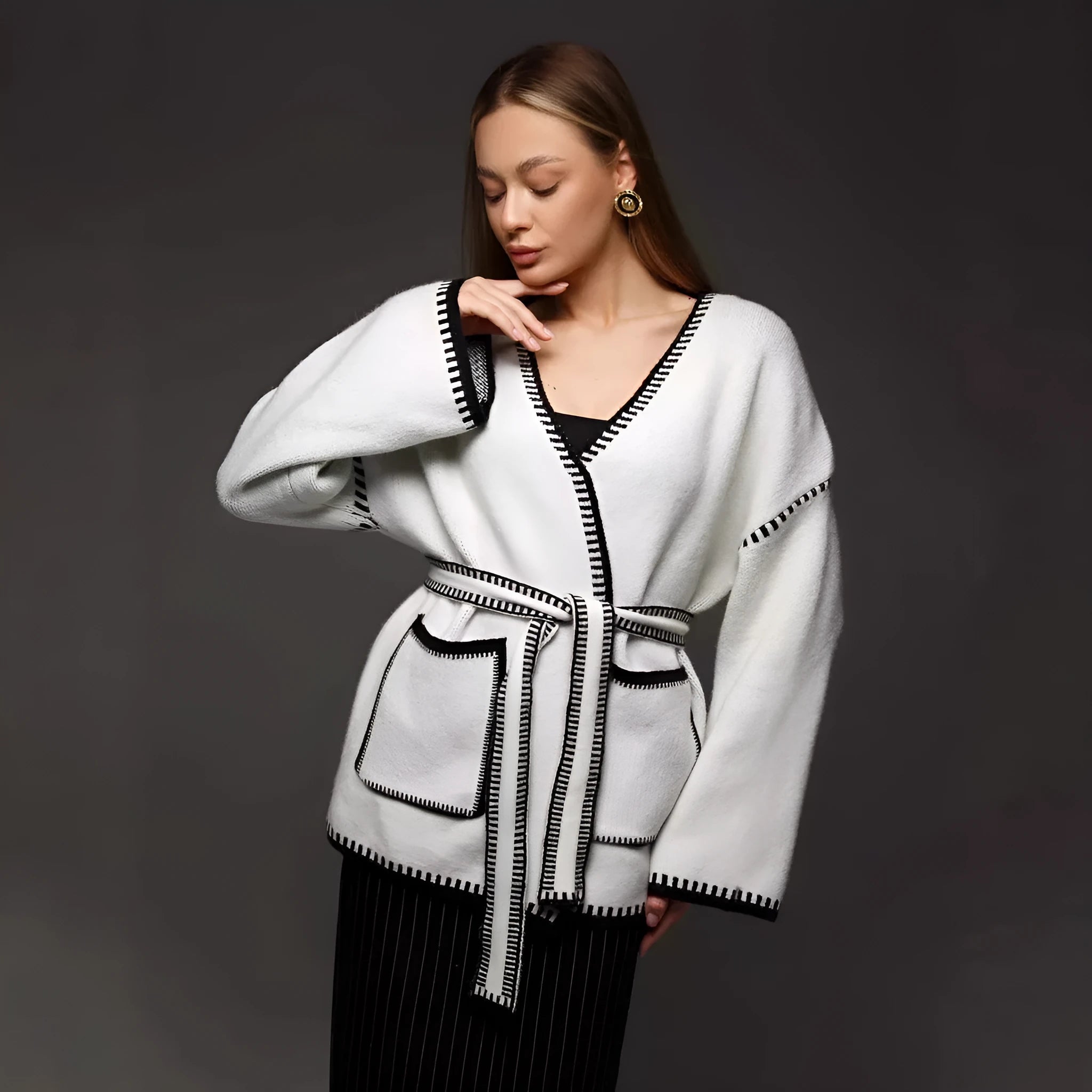 Lace-up front knitted cardigan sweater coat in camel colour, showing loose fit and long sleeves.