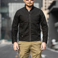 Men's brown tactical assassin jacket with camouflage pattern and multiple pockets.