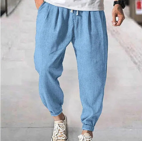 Men's loose casual cotton trousers with an elasticated ankle band in light green.