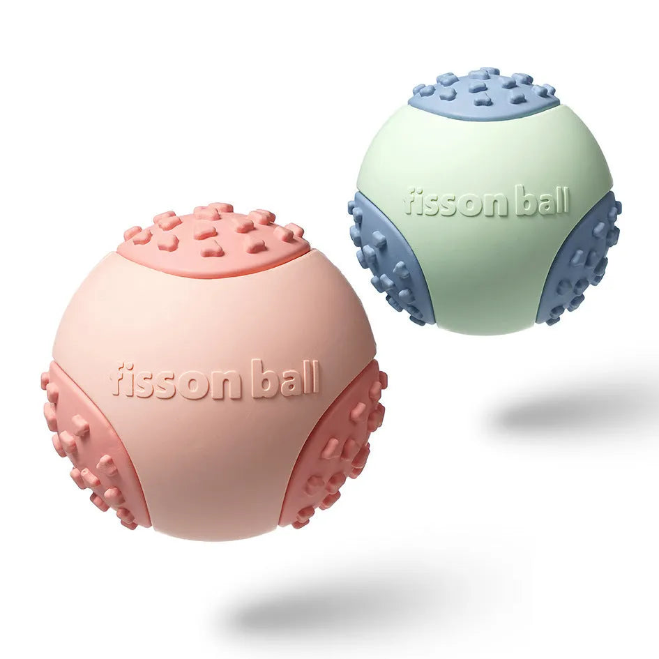 Green rolling ball dog toy on wooden floor showing 64mm diameter