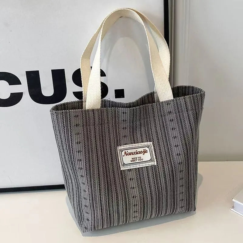 Japanese style corduroy handbag in dark brown showing textured fabric and minimalist design.