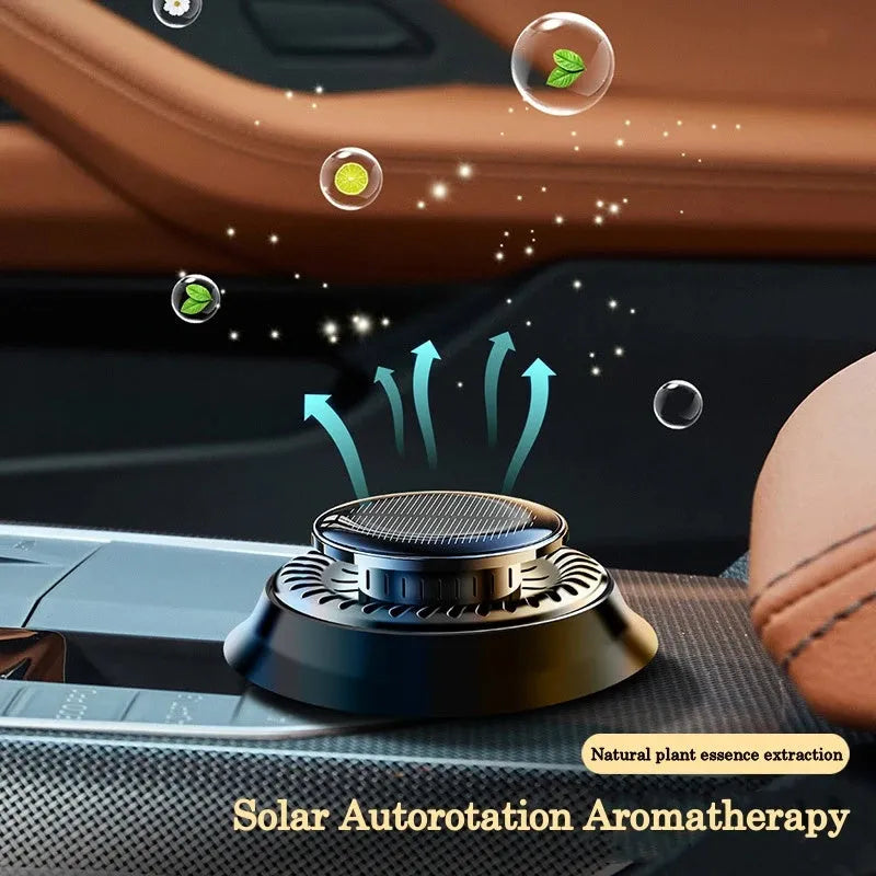Solar-powered kinetic car air freshener with rotating double rings on a car dashboard.