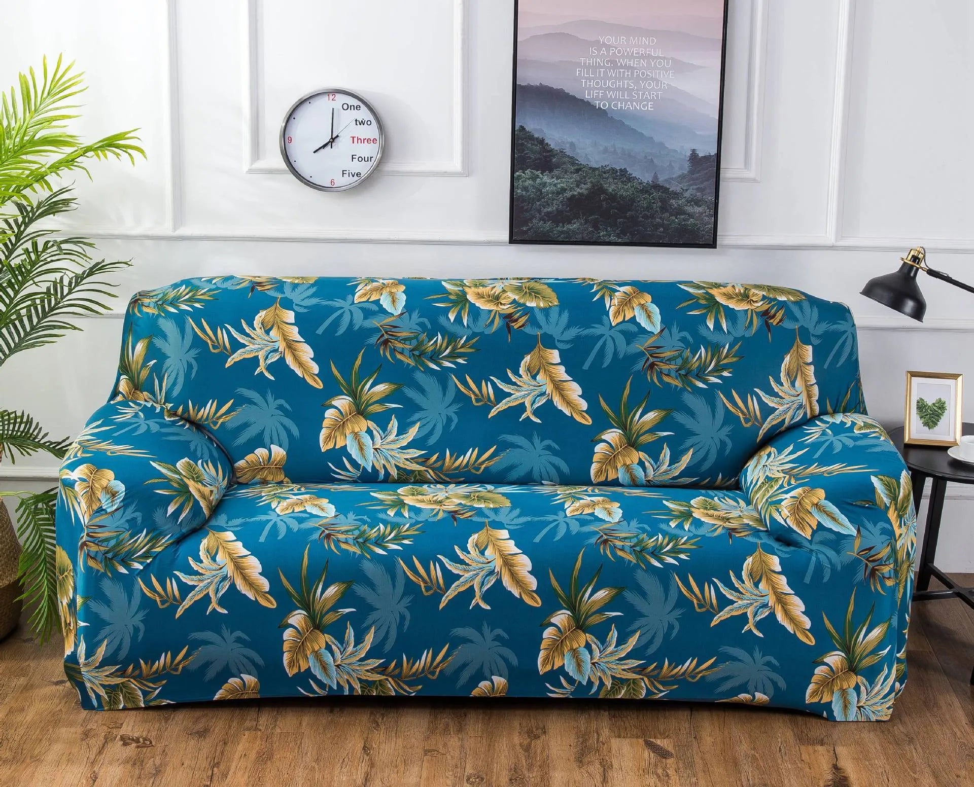 Geometric abstract printed stretch sofa slipcover covering a three-seater sofa with matching cushion covers.