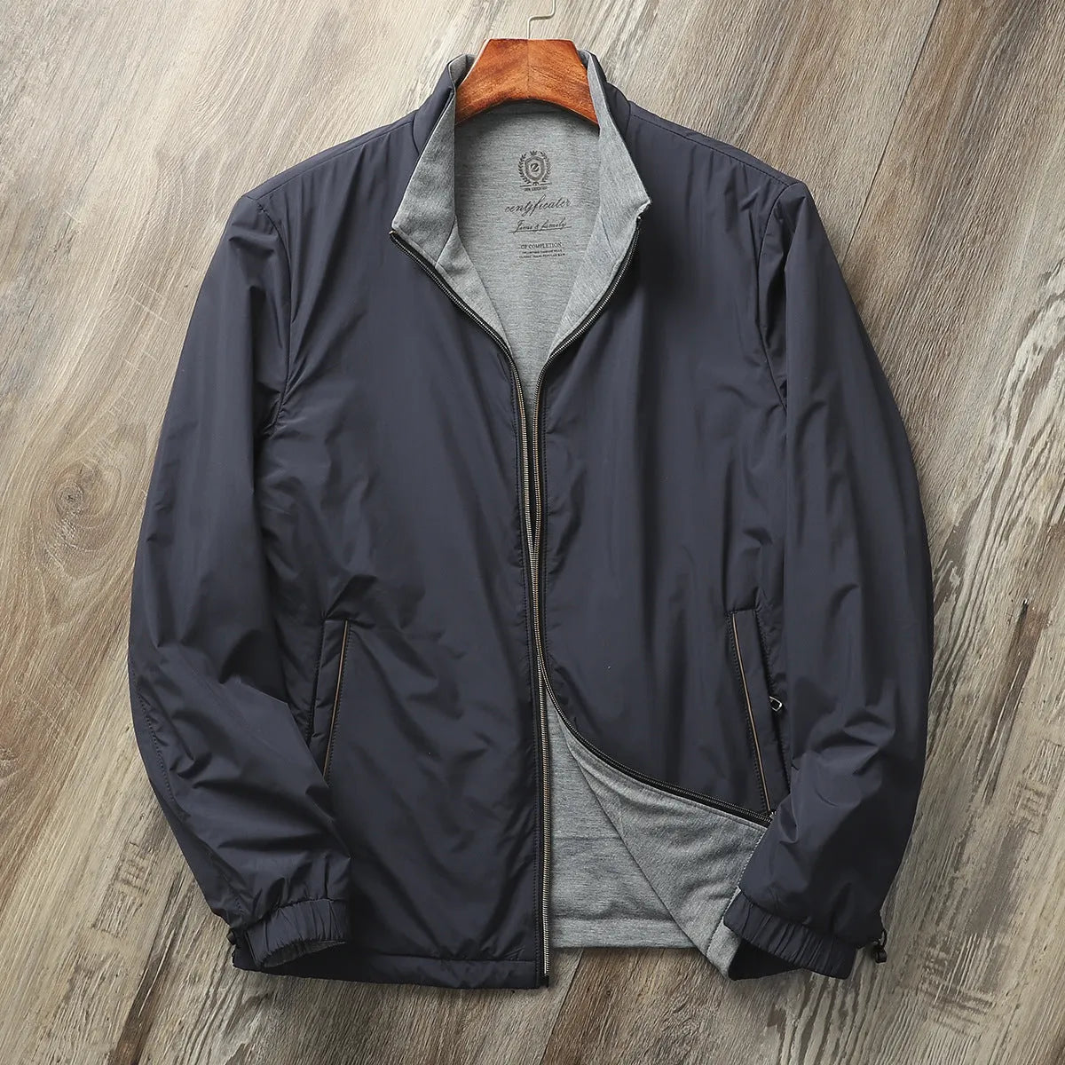 Men's simple stand collar casual jacket in polyester blend fabric, shown on a hanger.