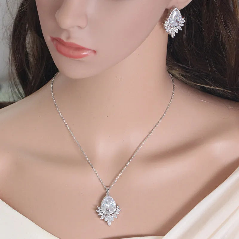 Silver-tone formal jewellery set with simulated diamonds and crystals, includes necklace and bracelet in blue, red, or white.