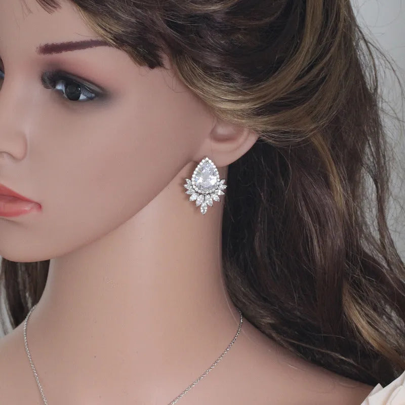 Silver-tone formal jewellery set with simulated diamonds and crystals, includes necklace and bracelet in blue, red, or white.